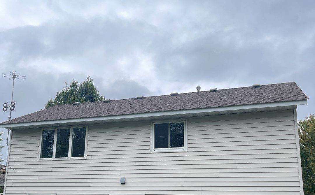 Back of a two-story vinyl-sided home in Sauk Rapids, MN, photographed by Repair King during an October 2021 exterior inspection