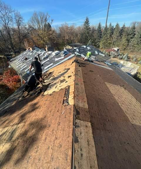 Repair King crew tearing off an old roof in Mendota Heights, July 2023