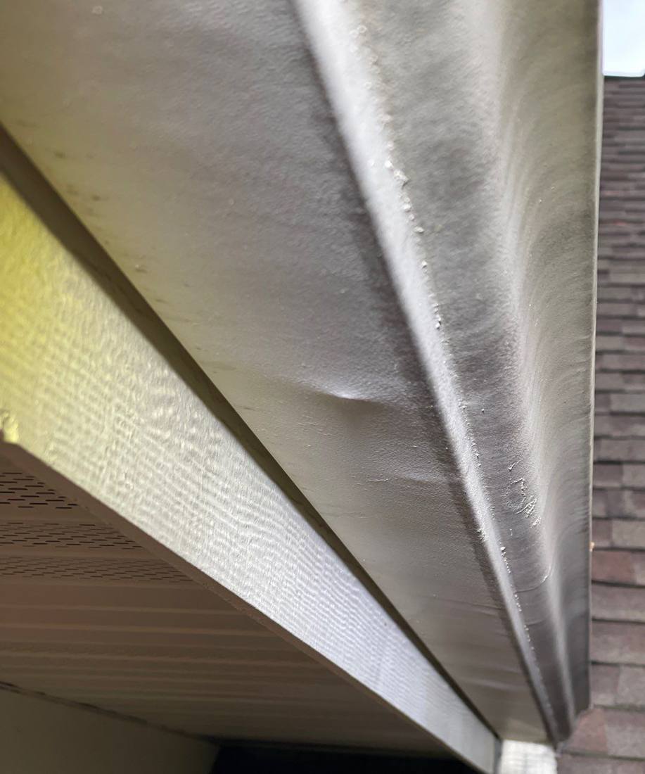 Hail dents along a Woodbury gutter, May 2022