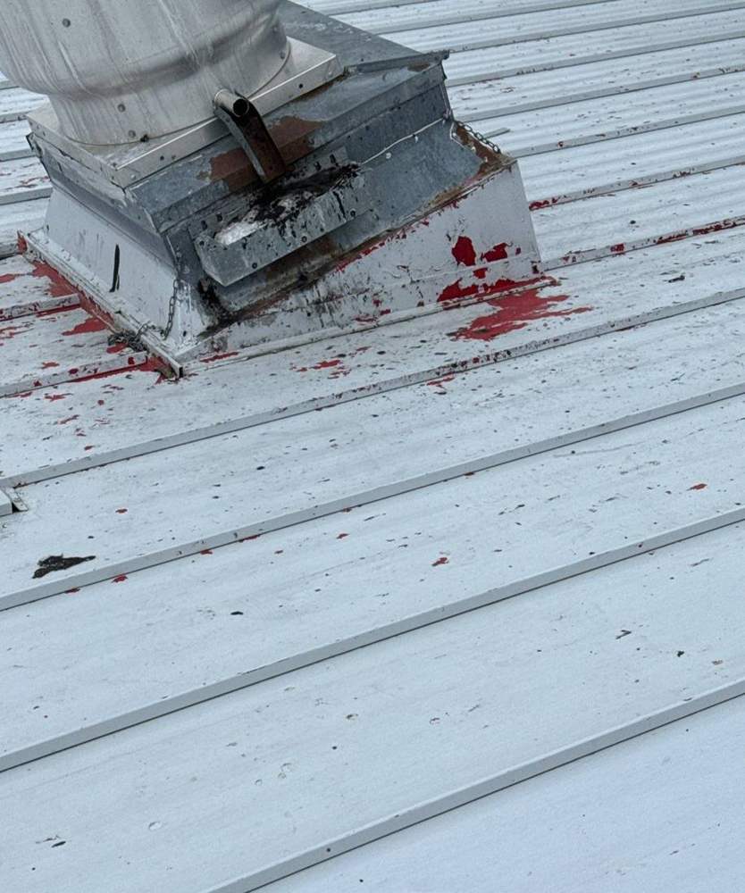 Hail dents in the metal roof and rooftop unit flashing at the Delano Dairy Queen, November 2023