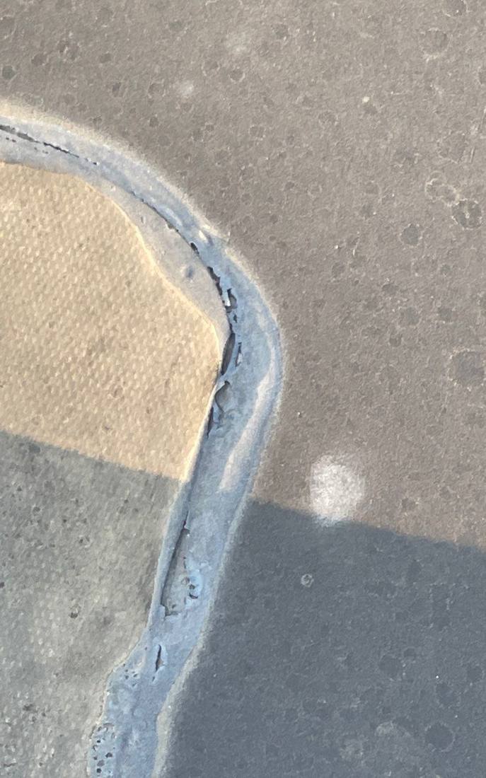 Cracked flat-roof membrane detail from a commercial inspection on Highway 55, September 2022