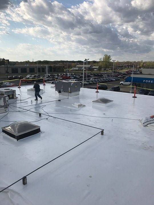 The finished white Duro-Last roof and domed skylights on the Forest Lake Chrysler Jeep Dodge building