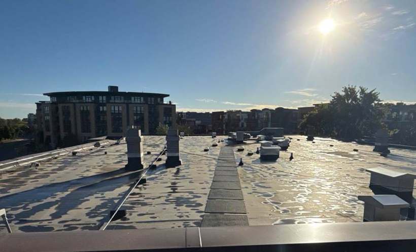 Flat membrane roof with rooftop vents on Wolfe Lake Condos in St. Louis Park, MN, October 2024