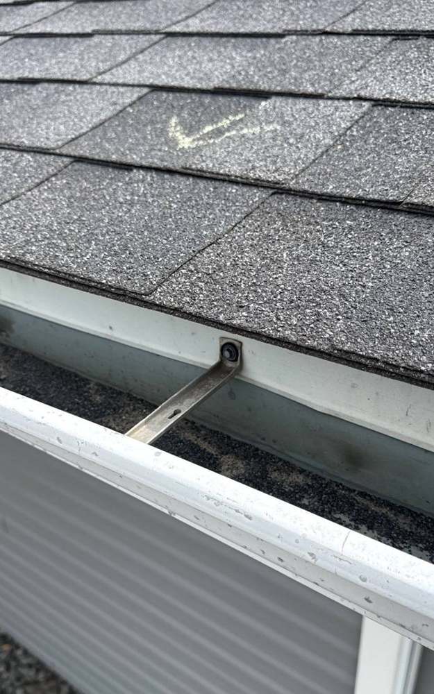 Gutter hanger and chalk-marked hail hit on a Lake City church roof, April 2026