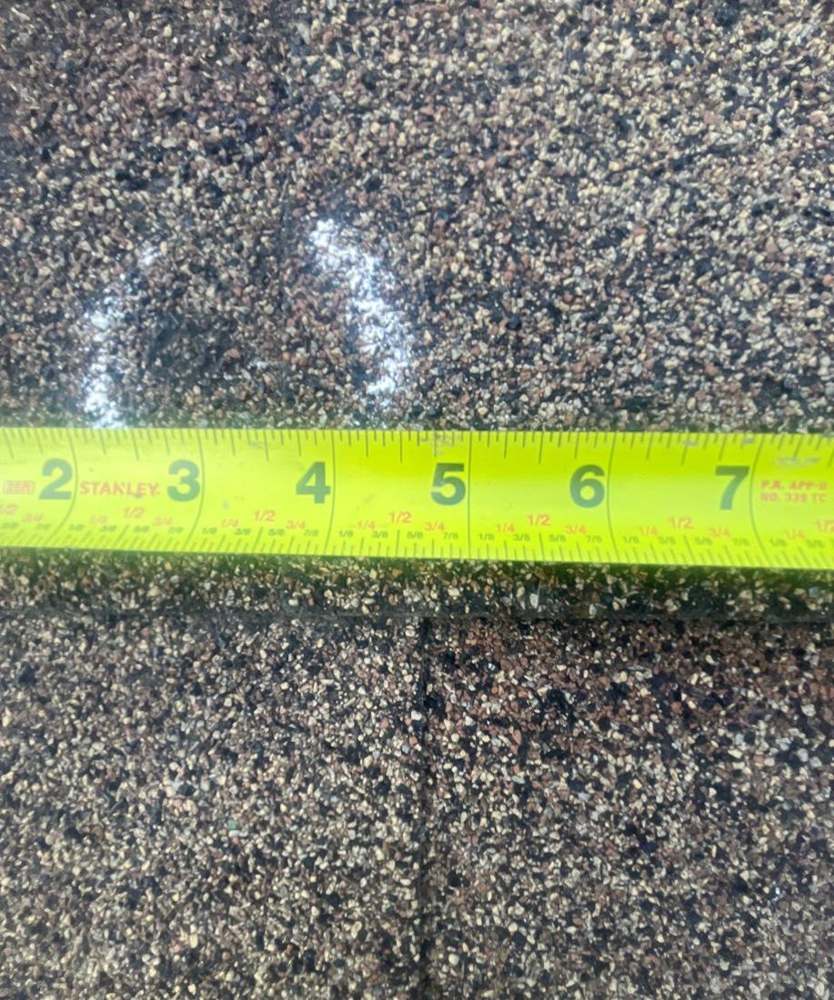 Hail hit chalk-circled and measured on a Hutchinson home's shingles, June 2024