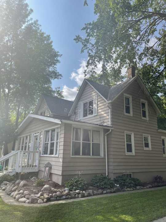 The side porch and gables of the older New Prague home, August 2021