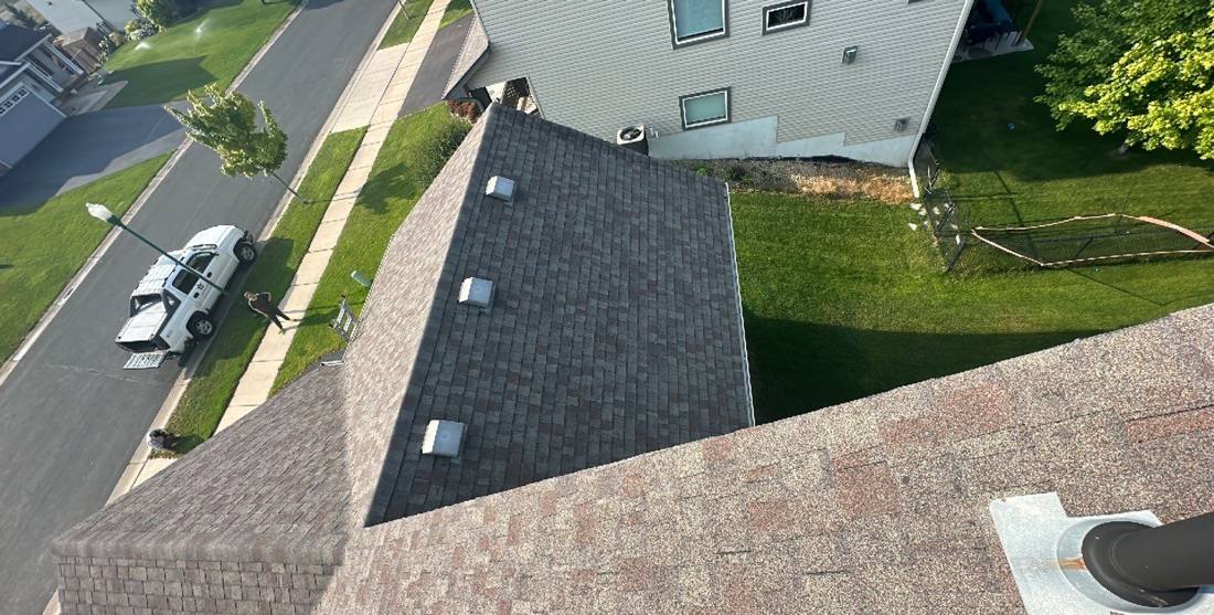 Aerial view down a Farmington roofline toward the street, July 2023