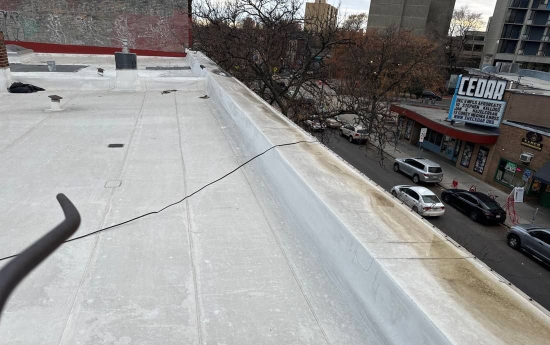 White membrane flat roof of Sagal Restaurant on Cedar Avenue in Minneapolis, with the Cedar Cultural Center marquee across the street