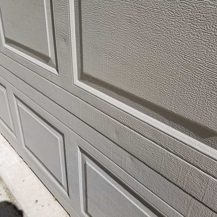 Garage door panels photographed during the Hugo inspection, because hail and wind don't stop at the roof