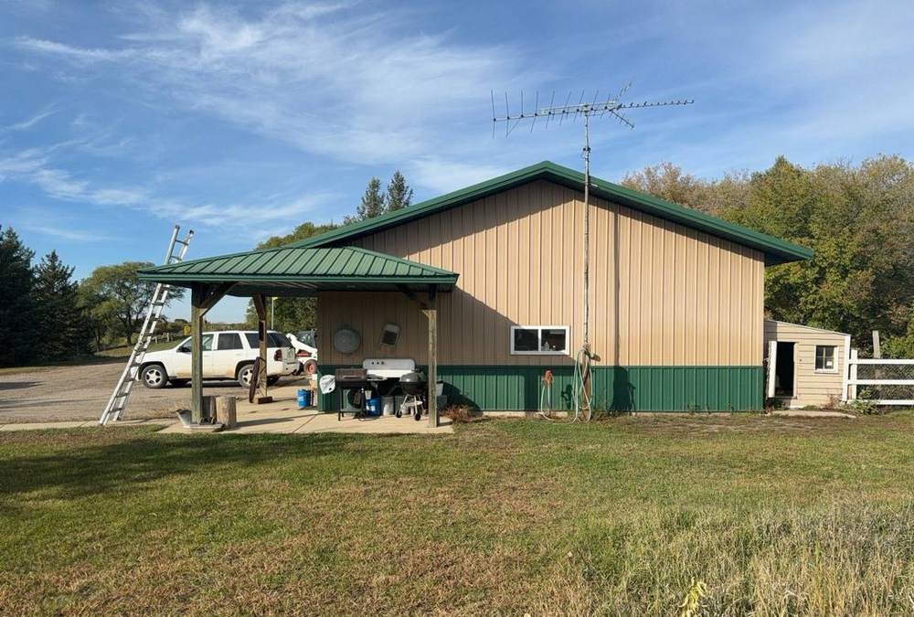 Metal-roofed pole-building machine shed with green trim on a Dassel-area farm property, inspected by Repair King in October 2023