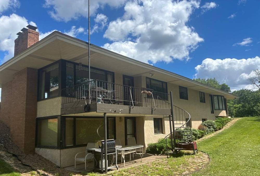 Rear elevation and deck of a mid-century Fridley home photographed during a roof inspection, June 2026