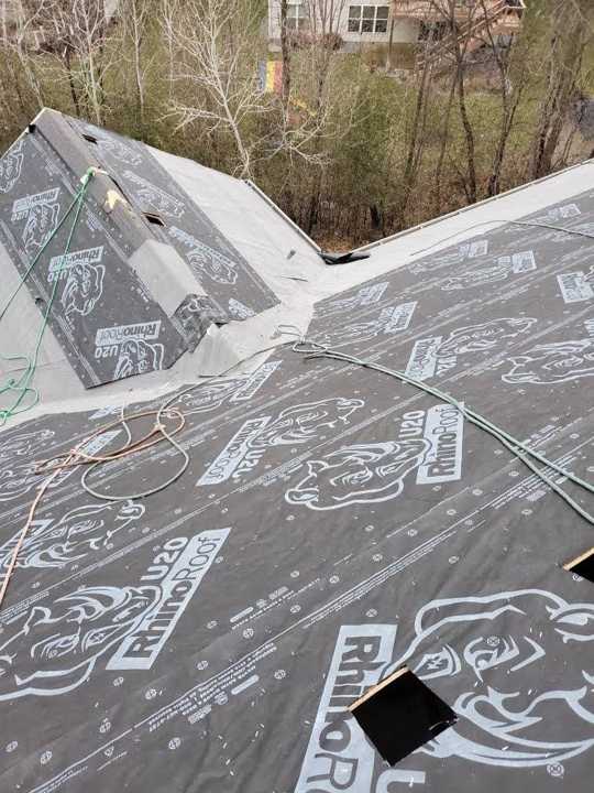 New synthetic underlayment and ice barrier going down on a Maple Grove re-roof, from the same job album