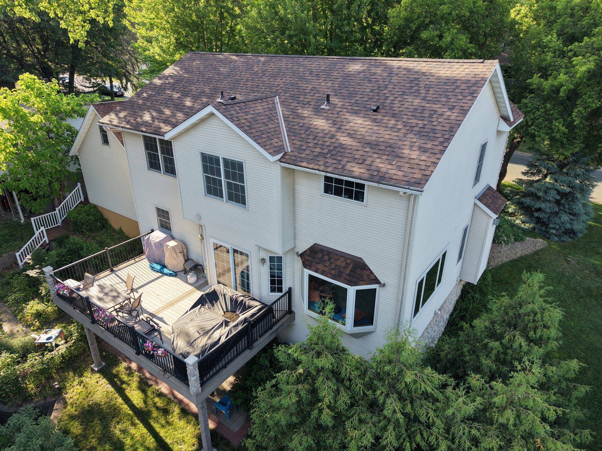 New architectural shingle roof on a two-story Twin Cities home, aerial drone photo by Repair King