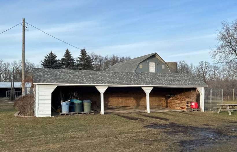 Detached garage with an open shed on a farmstead near Little Falls, January 2024