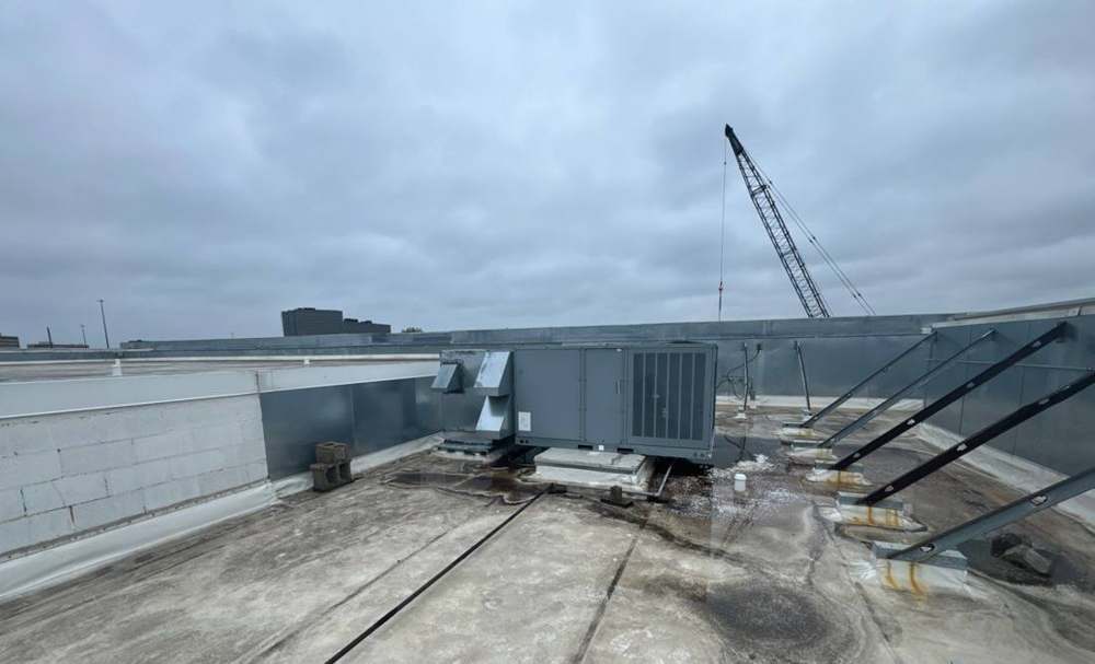 Rooftop units and the old flat roof on the Bloomington Lincoln dealership in Bloomington, MN, during Repair King's July 2024 inspection