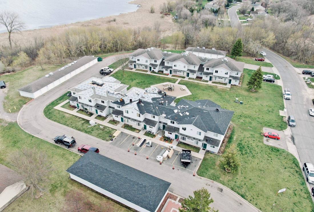 Aerial view of a Rochester townhome community during a roof replacement, April 2024