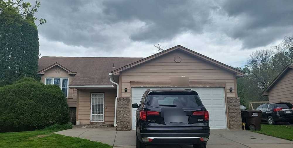 Oakdale split-level home under a stormy sky before an inspection, May 2022