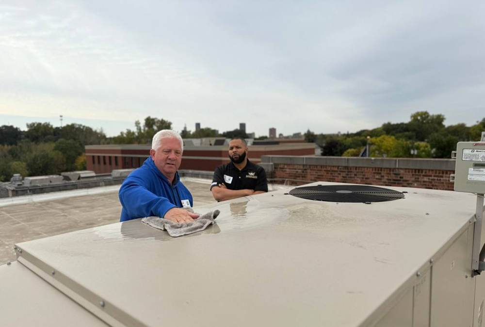Two Repair King team members on the HOPE Community Academy roof in St. Paul, October 2024