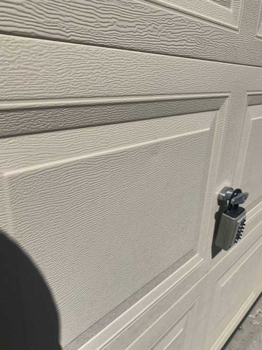 Garage door panel checked for dents at a Rockford home, July 2020