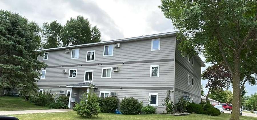 Three-story apartment building on North Welco Drive in Montgomery, MN, during a Repair King roofing and siding project