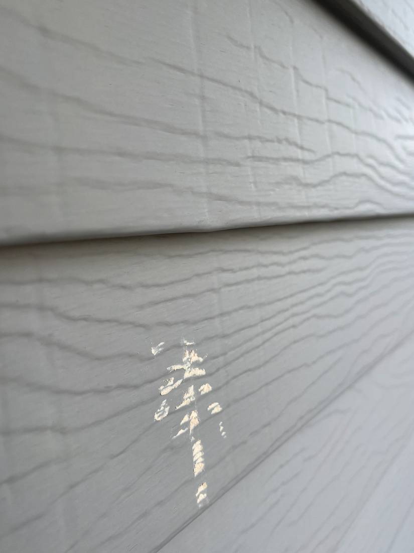 Chalk-marked hail hit on the textured vinyl lap siding of the GrandStay Hotel in Waseca, MN