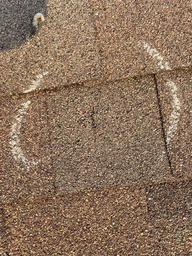 A chalk-circled hail hit on a Pinecone Villas shingle in Sartell, September 2021