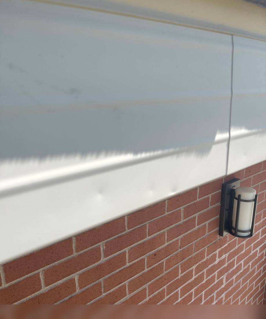 Soffit and eave detail on the St. Stanislaus Kostka Church brick tower, photographed during a roof inspection, May 2022