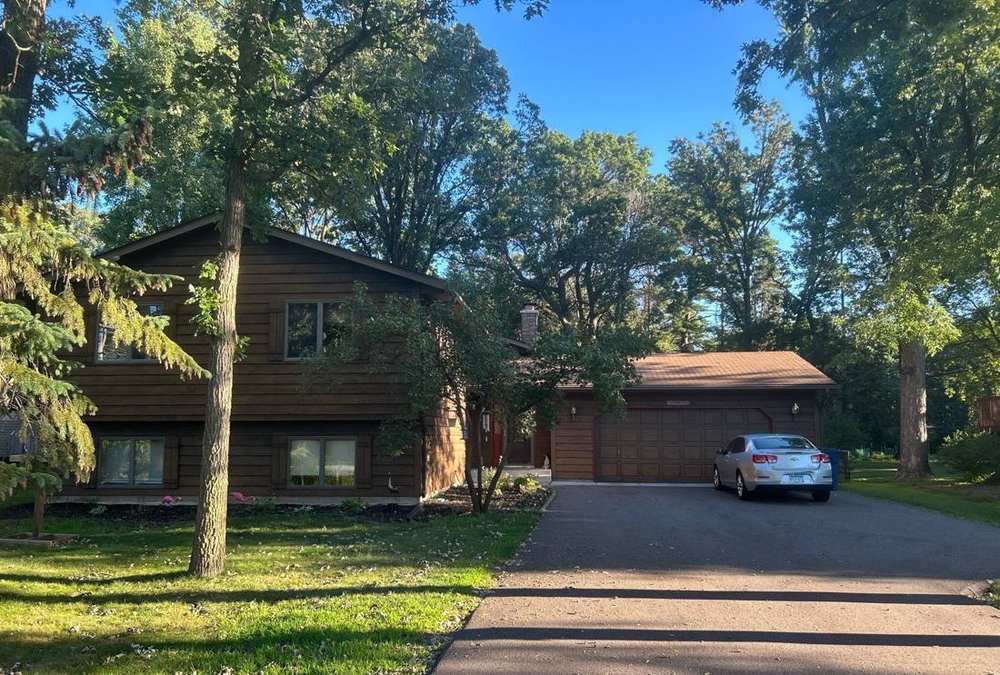 Cabin-style split-level home in White Bear Lake photographed during a roof inspection, August 2025