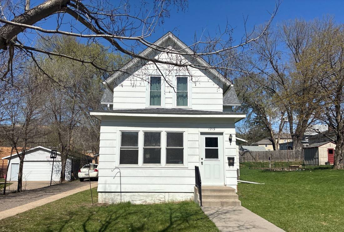 White 1½-story house with a steep gable and enclosed front porch in Red Wing, MN, during a Repair King storm inspection, April 2026