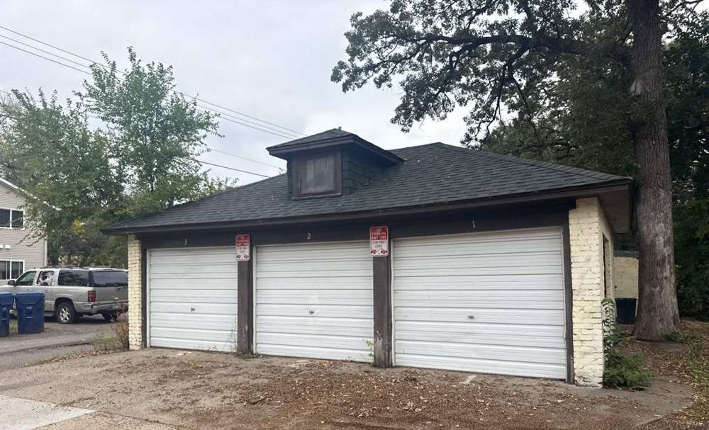 Detached three-stall stucco garage at a St. Cloud home during a Repair King roof project, September 2025