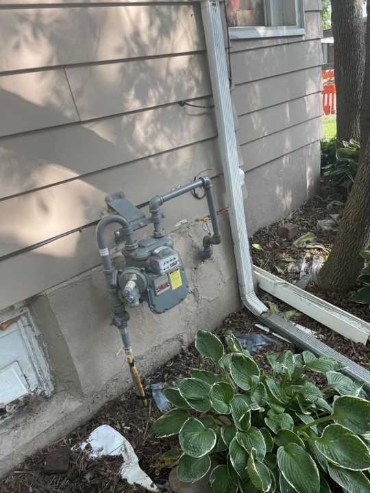 Siding and downspout on the back of the New Prague home, August 2021