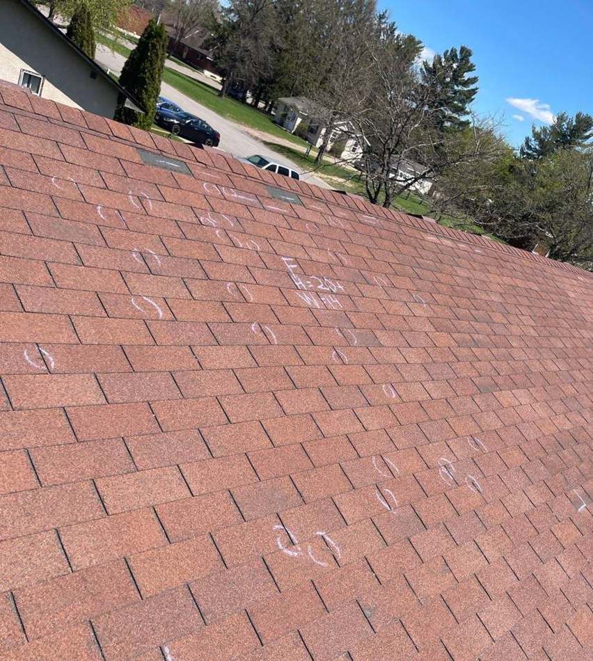 Chalk-marked hail hits across the shingle roof at Candy Cross Apartments in Princeton