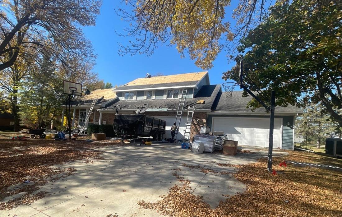 Full roof tear-off underway on a Pine Island two-story home, October 2022