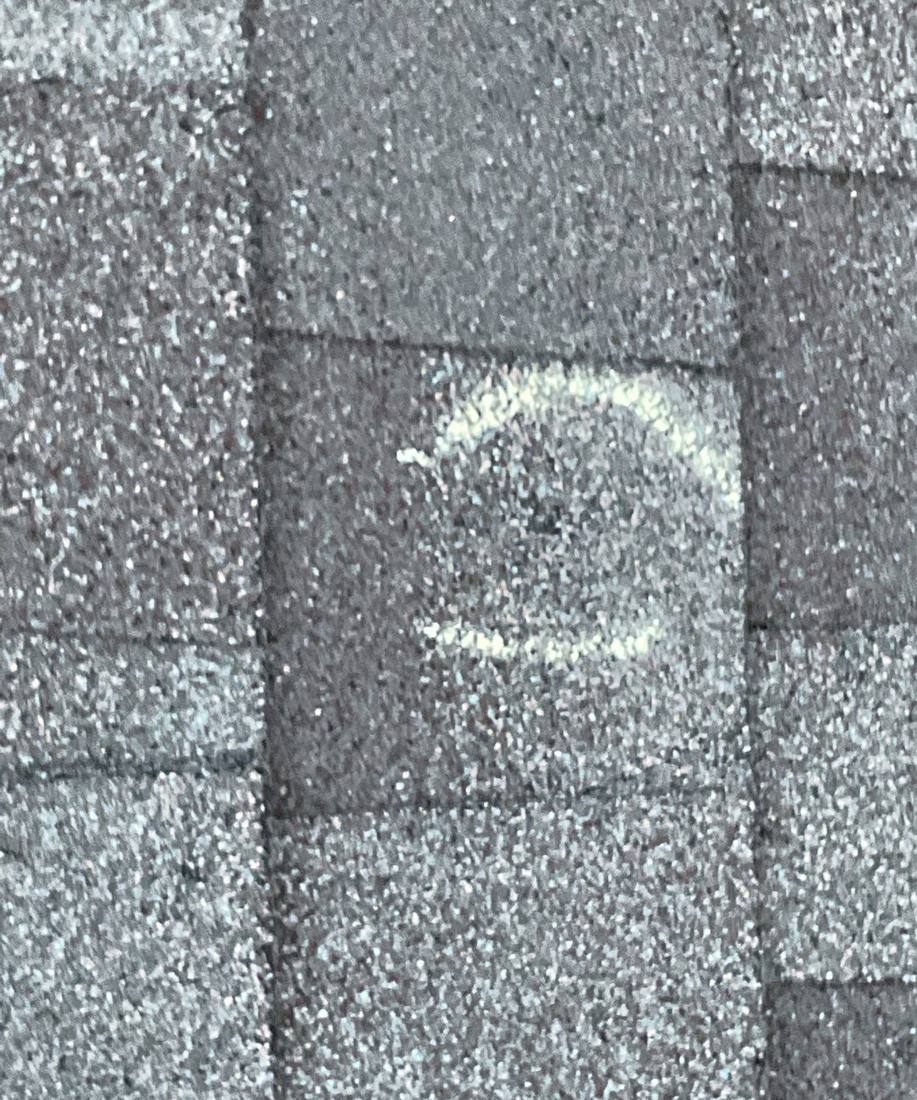 Hail hit chalk-marked on a Savage roof slope during an inspection, May 2023