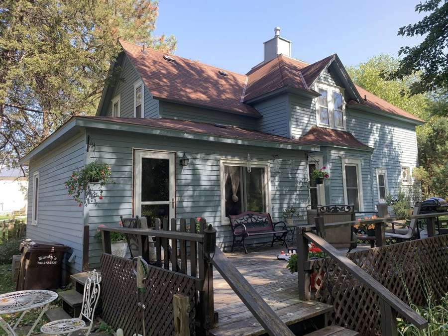 Rear of an older two-story clapboard home with a deck in Watertown, MN, photographed during a Repair King inspection