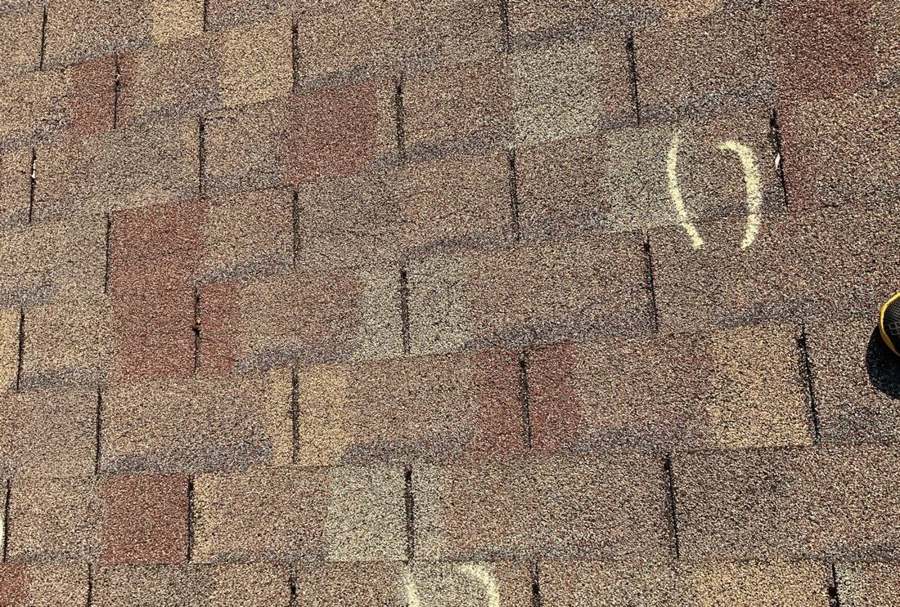 Hail hits chalk-marked on a Montgomery roof slope during an inspection, June 2023