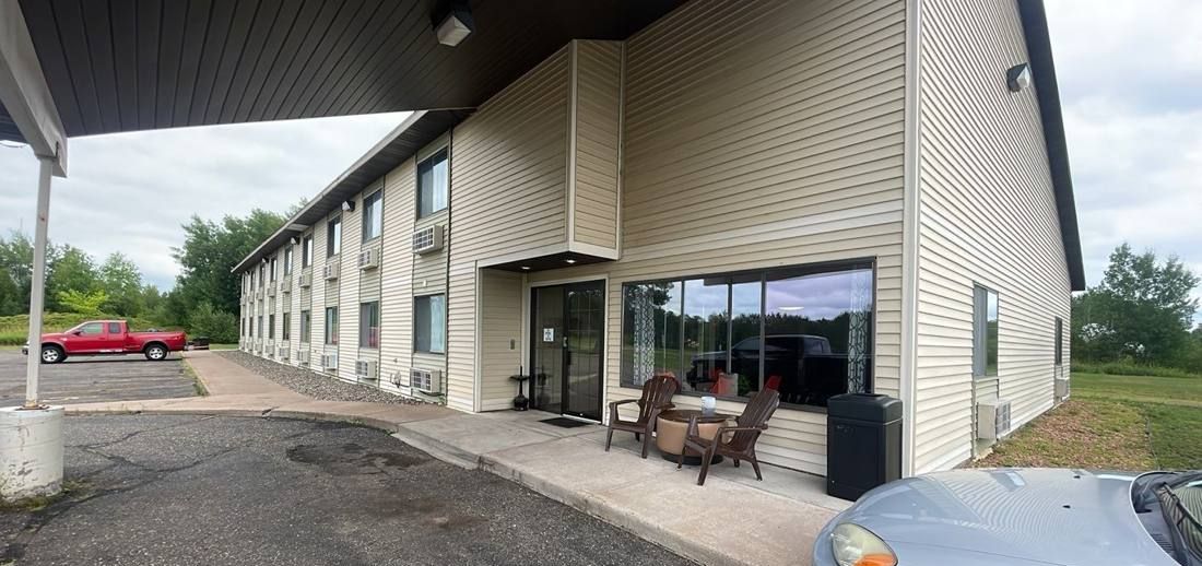 Two-story America's Quality Inn & Suites motel with vinyl siding on Highway 23 in Finlayson, MN