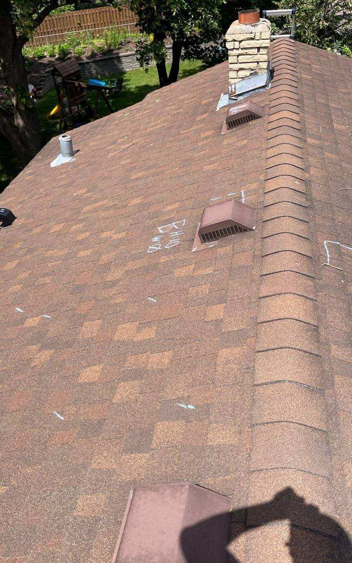 Chimney and roof vents on a White Bear Lake home, chalk-marked during an inspection, June 2022