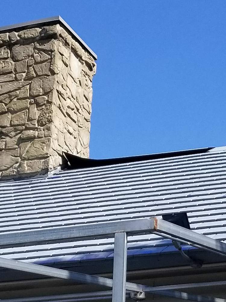 The metal roof section and stone chimney on the Good Earth building in Roseville