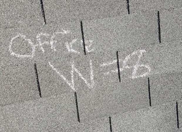 Hail count chalked on a Maplewood townhome slope: "Office W=8" on the west slope of the office building