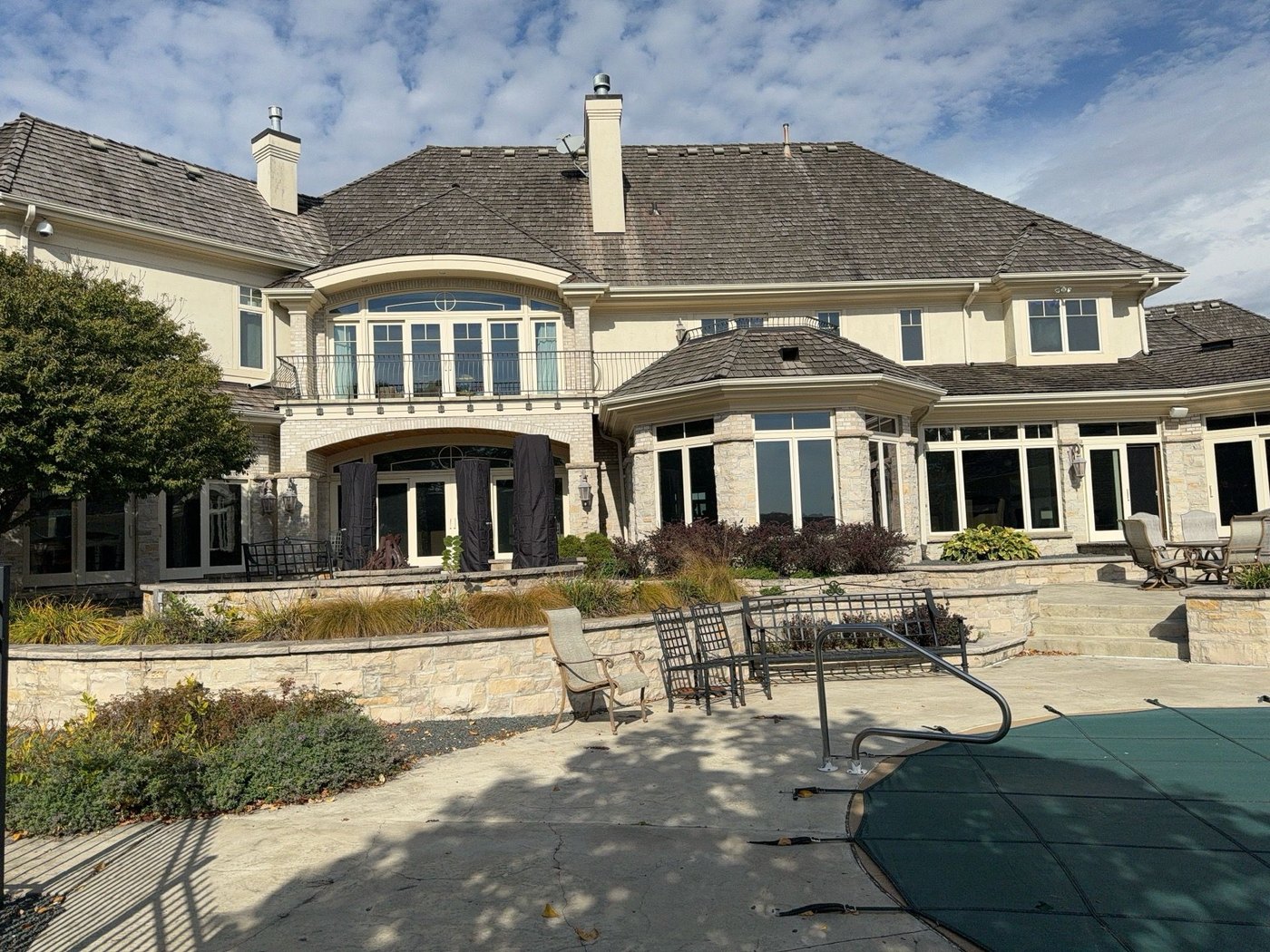 Rear elevation and cedar shake roof of the same estate above the pool terrace, October 2023