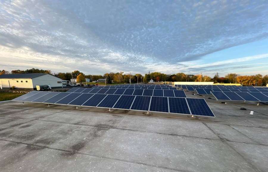 Solar panels and low-slope roof on The Marketplace grocery store in Cokato, MN, October 2023