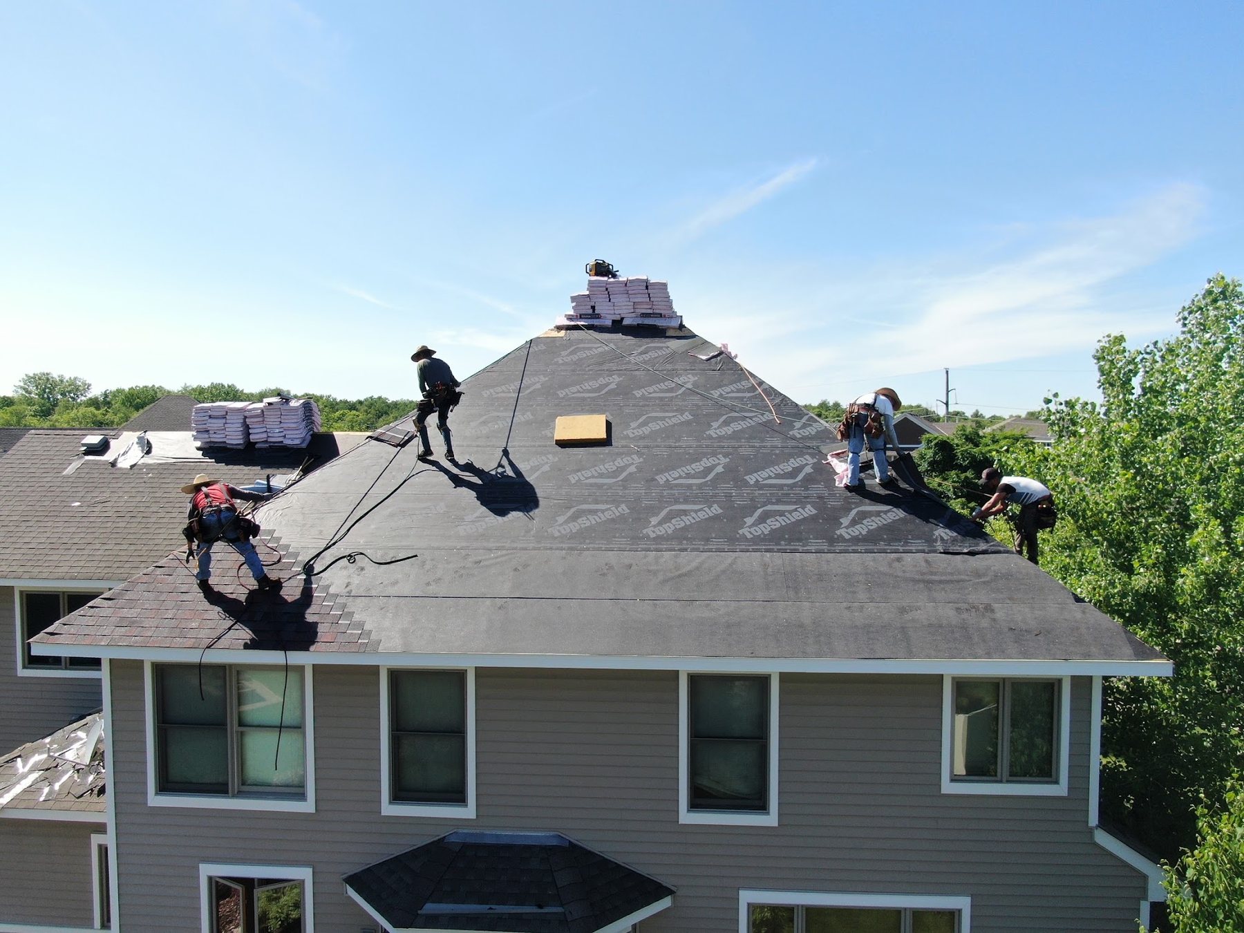 Repair King crew installing a new roof over synthetic underlayment