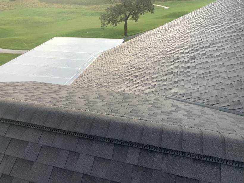 Shingled roof of the Coyote Moon Grille clubhouse overlooking the Territory Golf Club parking lot in St. Cloud, MN