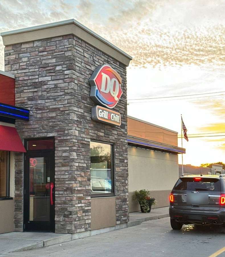 Stone veneer entrance tower of the Dairy Queen Grill & Chill in Cokato, MN at sunset, October 2023