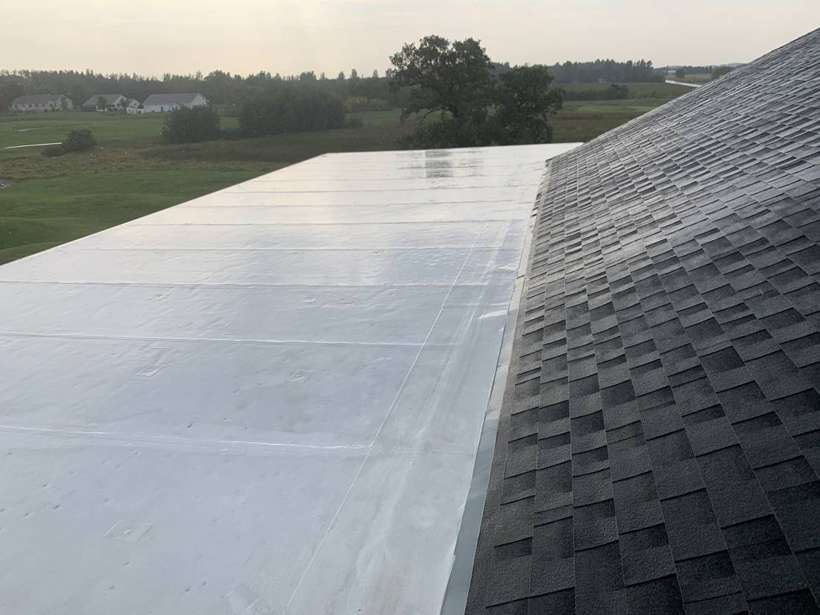 White Duro-Last flat roof section and new shingles on the Coyote Moon Grille clubhouse in St. Cloud, MN, a Repair King project