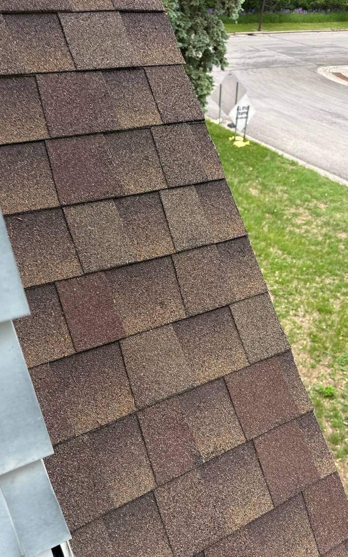 Close-up of architectural shingles on a New Ulm roof slope, May 2026