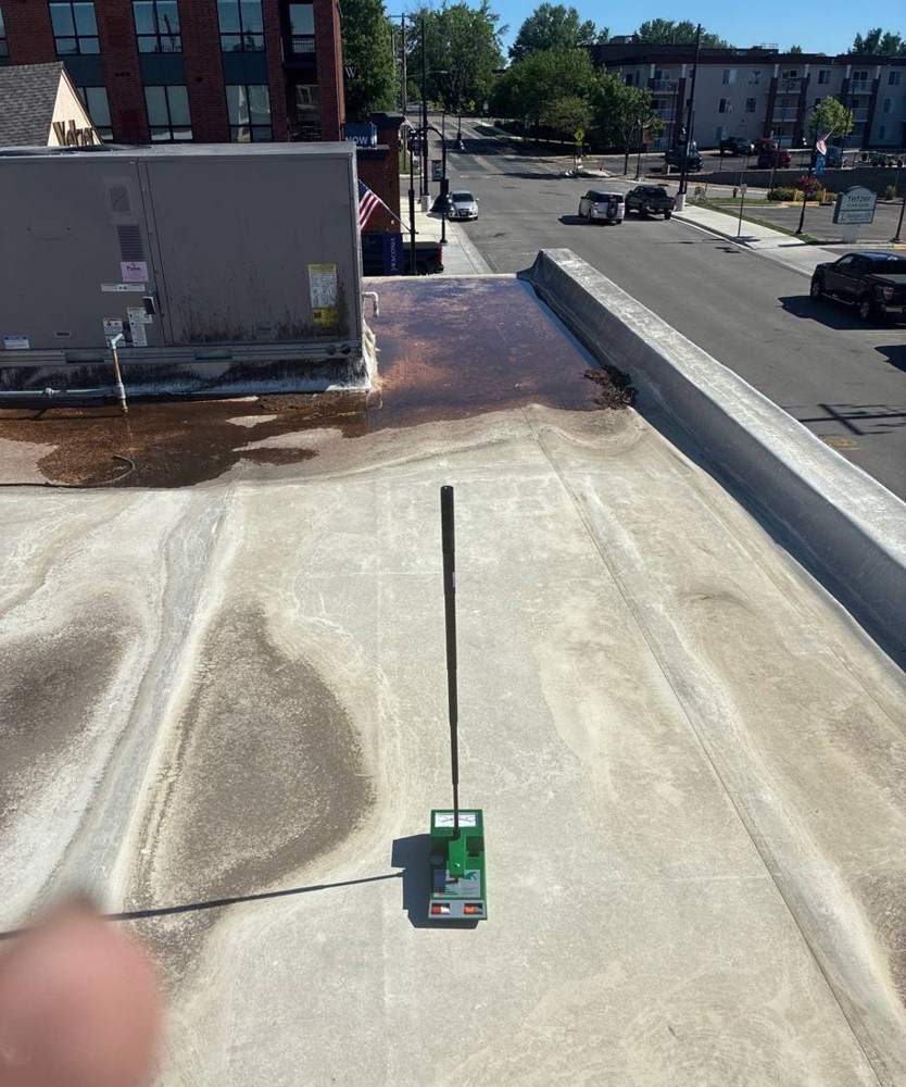 Repair King moisture-scanning the flat roof above Hoppers Bar & Grill in downtown Waconia, MN, looking out over Main Street