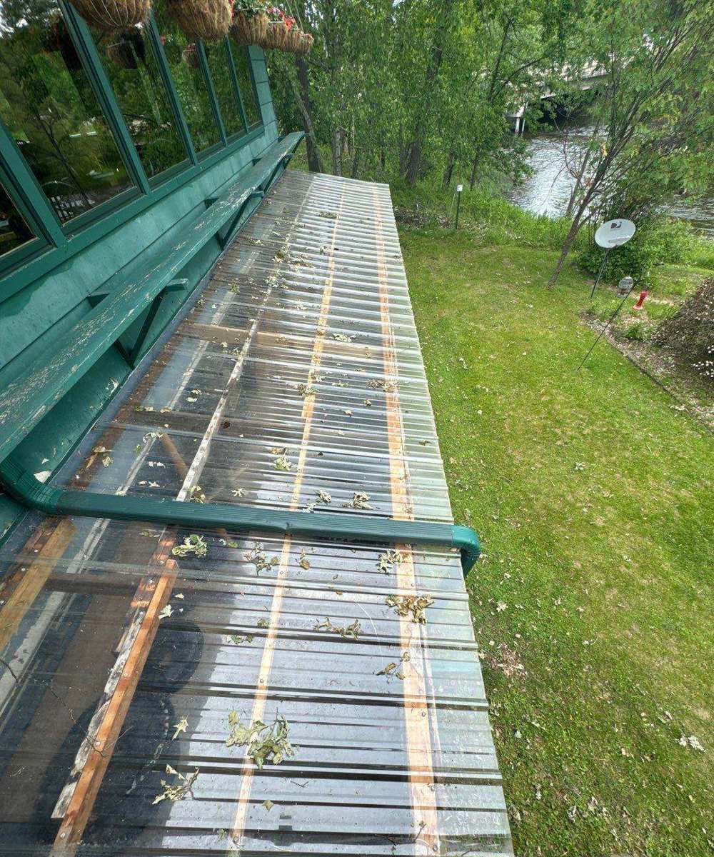 View of the Pine River from the roof of the Riverside Tavern & Inn in Crosslake, MN, during a June 2024 roof inspection