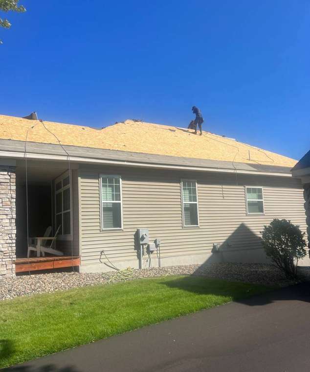 Repair King crew working on a bare roof deck during an Apple Valley re-roof, August 2023